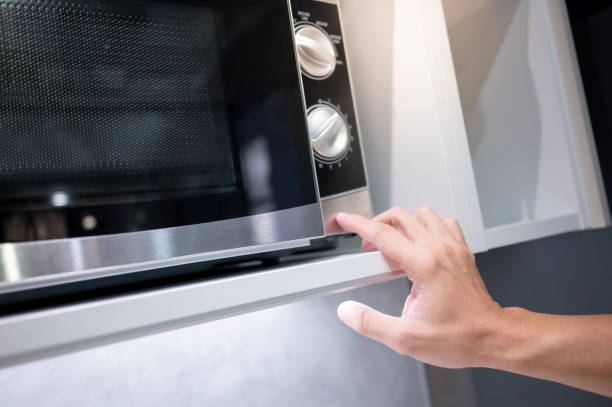 istock Male hand opening microwave door 1445450852