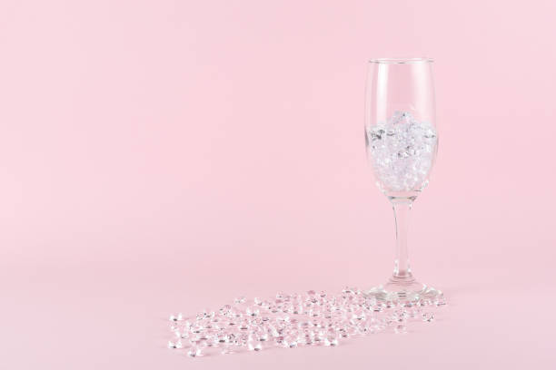 istock Diamonds and wine glass on pink background. Creative minimal party concept. 1445457133