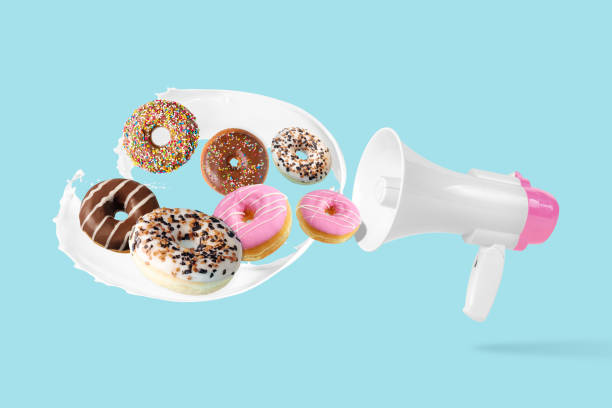 istock Different tasty donuts with megaphone on pastel blue background. Creative minimal food concept. 1445457146