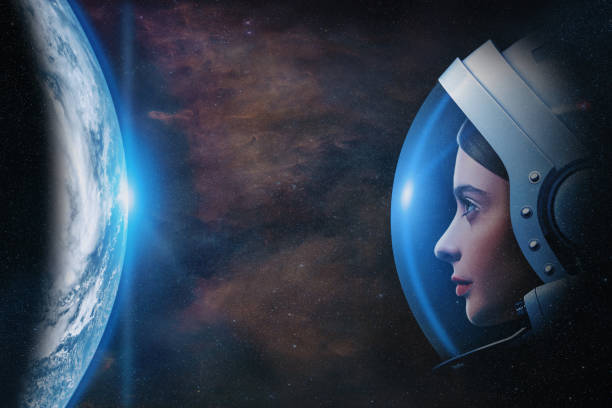 istock Attractive woman astronaut against Earth planet in outer space. Elements of this image furnished by NASA. 1445457191