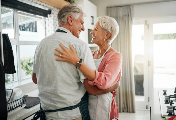 istock Cooking dance, dinner and senior couple dancing with smile while making lunch in the kitchen of house. Happy elderly man and woman doing jazz movement with love to music while preparing food in home 1445457282