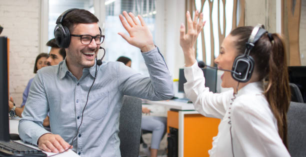 istock Customer service support operators giving high five to each other and celebrating successful completed task. 1445460189