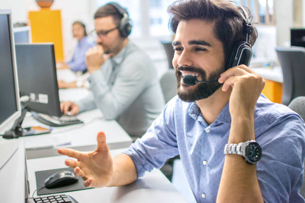 istock Portrait of smiling assistant using a headset in a call center. 1445460293