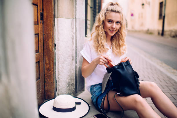 istock Content trendy woman with backpack on street steps 1445461427
