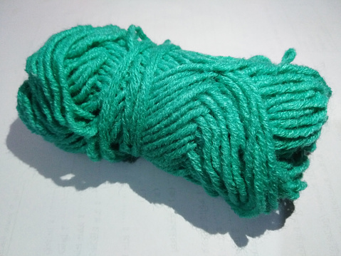 Bundle of wool yarn on white background. Apparel material for knitting fabrics.