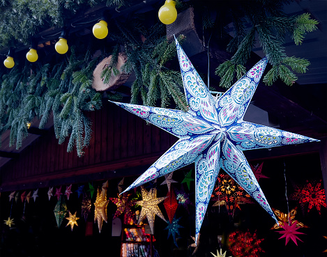 Christmas star at the Christmas market under the roof of the stall