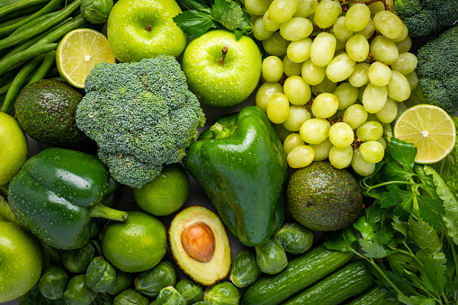 Assortment of raw organic green fruits and vegetables.