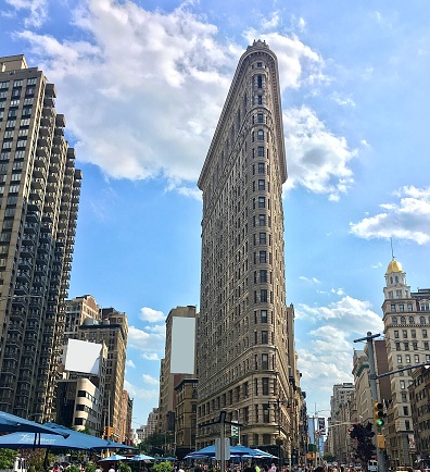 A pedestrian's perspective of buildings and sky in downtown New York City.