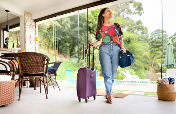 istock Young woman with a suitcase arriving at her vacation rental accommodation 1445475714