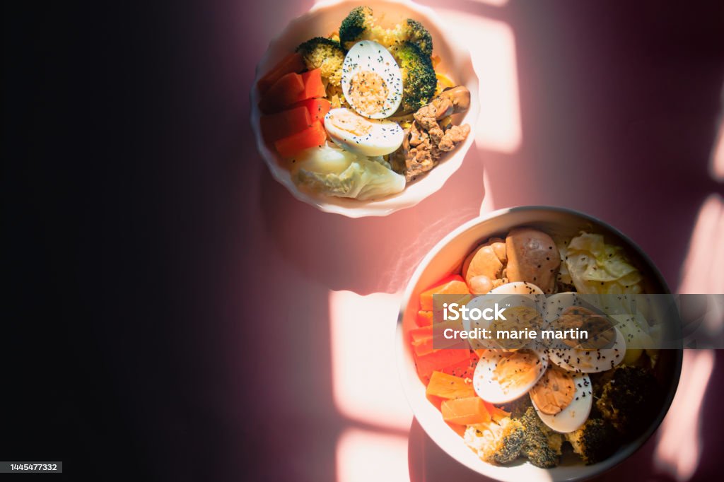 Top view of two bowls of high protein keto meal Top view of two bowls of high protein keto meal made of steamed carrots, broccoli, cabbage, egg and chicken liver Alternative Therapy Stock Photo