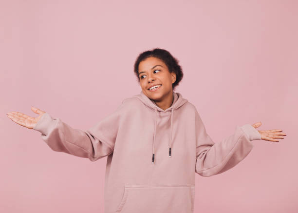 istock Smiling girl shrugging her shoulders. 1445480878