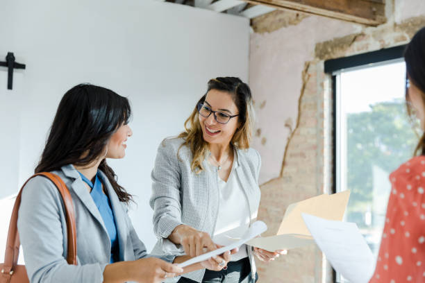 istock Female real estate agent points out clause in rental agreement 1445481908