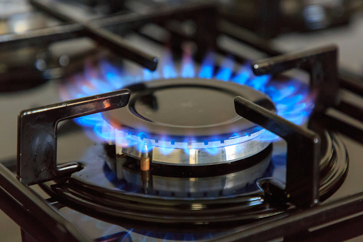 Blue flames of a natural gas hob cooker burner working
