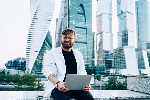 Very Positive Developer Portrait Of Positive Software Developer Sitting With Laptop Device And ...
