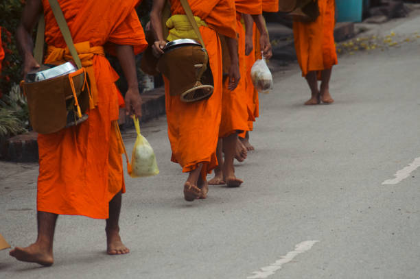 Buddhist monks during Sai Bat or Tak Bat, the traditional morning alms giving ceremony stock photo