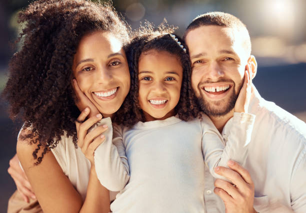 familie, lächeln und glückliches kind mit mama und papa bindung, glück und liebe zeigen, während sie im sommer draußen zusammen sind. porträt und gesicht eines mannes, einer frau und eines mädchens im freien zum entspannen in brasilien - offspring child toothy smile beautiful stock-fotos und bilder