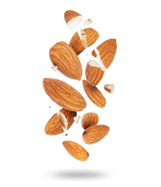 istock Whole and crushed almonds close-up in the air on a white background 1445488880