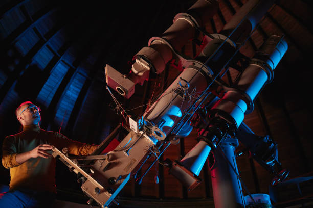 istock Astronomer with a big astronomical telescope in observatory doing science research of space and celestial objects. 1445488902