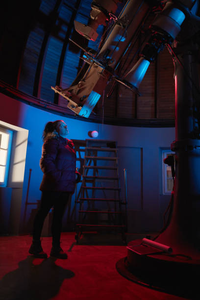 istock Astronomer with a big astronomical telescope in observatory doing science research of space and celestial objects. 1445488944