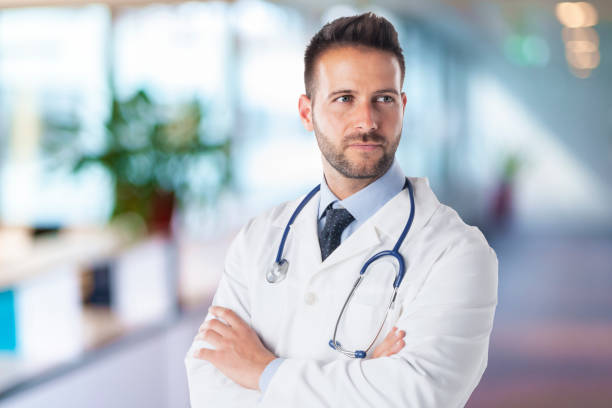 istock Male doctor portrait while standing at clinic 1445489180