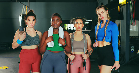 Portrait, fitness and gym with sports friends together in a health club for exercise or a training workout. Teamwork, support and diversity with a confident woman athlete group standing in sportswear