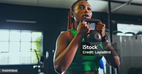 istock Exercise, kettlebell and black woman in gym, for fitness and workout for wellness, health and training. Healthy girl, African American female and athlete with equipment for practice, cardio or strong 1445492646