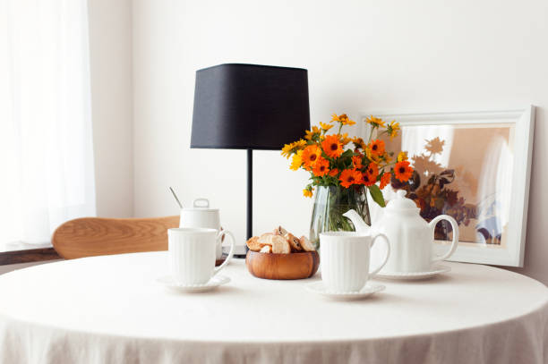 Table serving for morning fresh tea with tablecloth and flowers