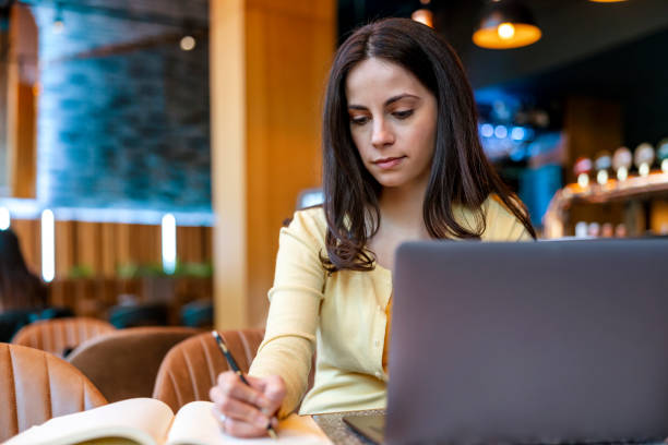 istock Woman using laptop at cafe 1445498476