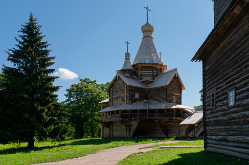 View of the Church of the Assumption of the Virgin in the Novgorod Museum of Folk Wooden Architecture of Vitoslavlitsa on a sunny summer day, Veliky Novgorod, Russia