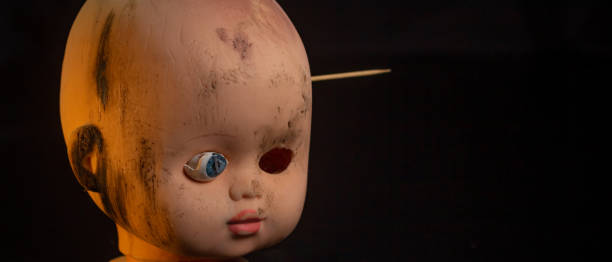 istock Damaged Dirty Doll head on black background isolated 1445501225