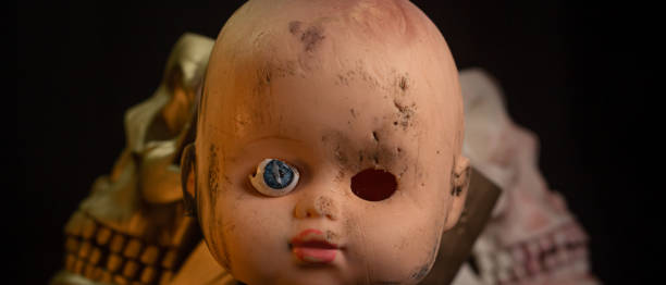 istock Damaged Dirty Doll head and skull on black background isolated 1445501247