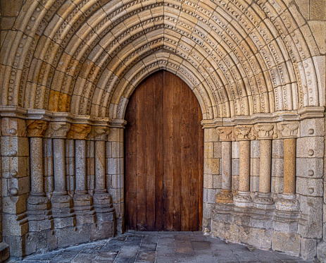 Ornate Romanesque door of the cloister of the Cathedral of Saint Mary of the Assumption in Viseu, Portugal