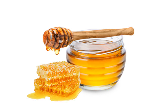 Honey isolated on white background. Honey isolated on white background. Jar with honey, honeycomb and honey dipper with drop of honey. honey stock pictures, royalty-free photos & images