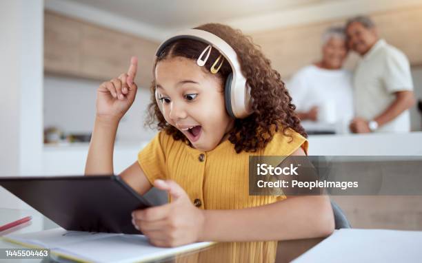 Excited Homeschool Tablet Or Girl With Ideas Learning Motivation Or Education Innovation In Homework Study On Headphones Smile Happy And Student Child With Technology In Senior Grandparents House Stock Photo - Download Image Now