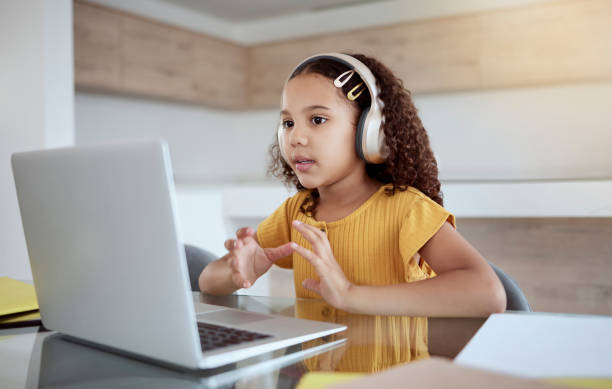 istock Girl, laptop and video call online for learning, education or study in her home. Child, computer and desk on video conference for education, communication or school on the internet in her house 1445504514