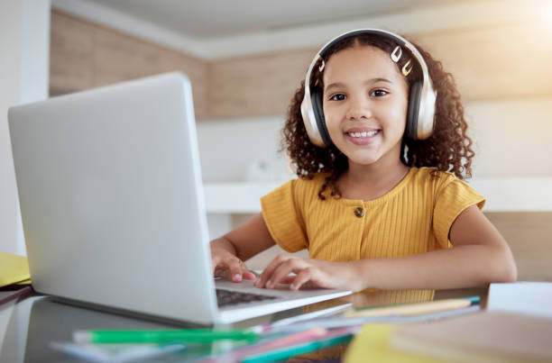 istock Learning, typing and girl on laptop with headphones on internet class, online studying or web elearning. Homeschooling, education and happy kid or child smile busy working on webinar course homework. 1445504517