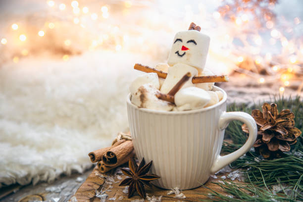 istock Christmas background with marshmallow snowman in a cup. 1445509204