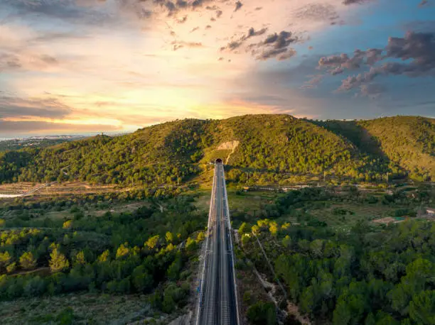 Photo of Bridge with railroad against mountains