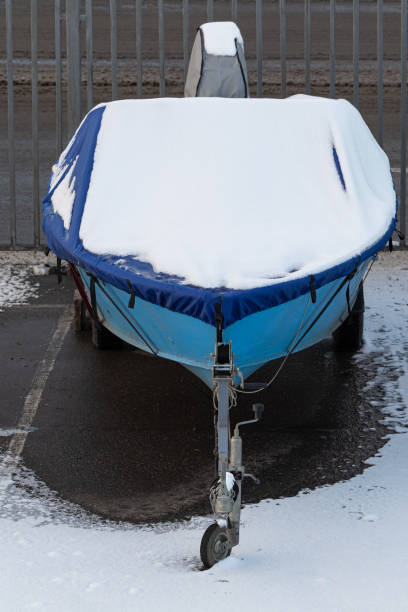 istock a boat covered with snow stands in the parking lot. 1445512125