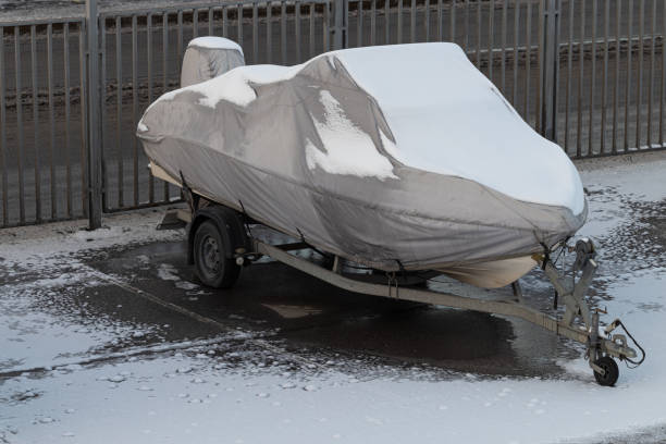 istock a boat covered with snow stands in the parking lot 1445512138