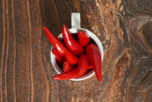 Red hot chili pepper on old wooden background.