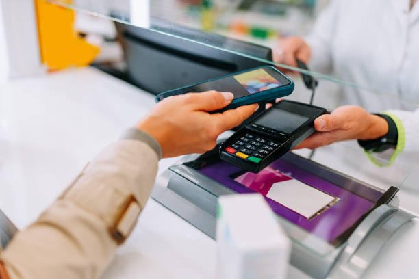 istock Woman paying with mobile app at pharmacy. 1445512374