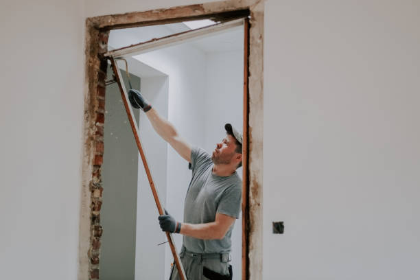 istock A man working with a crowbar in a doorway. 1445513713