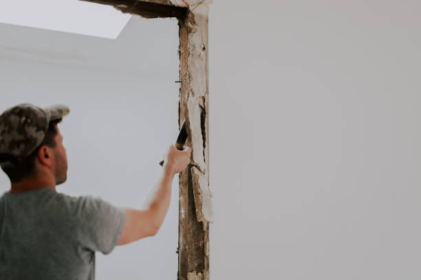 istock A man working with a crowbar in a doorway. 1445513721