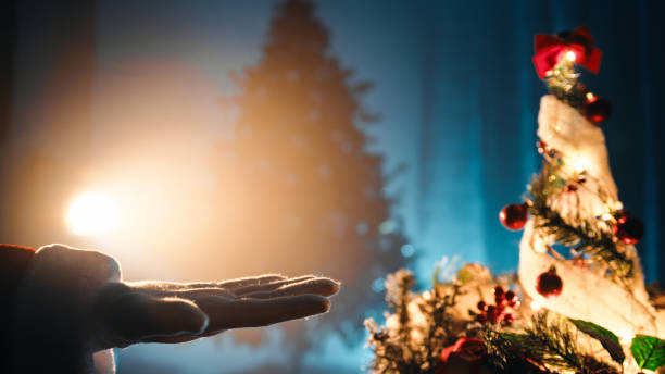 istock Santa Clause's Hand On Beam Of Light 1445514191
