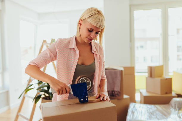 istock Woman packing to move. 1445514703