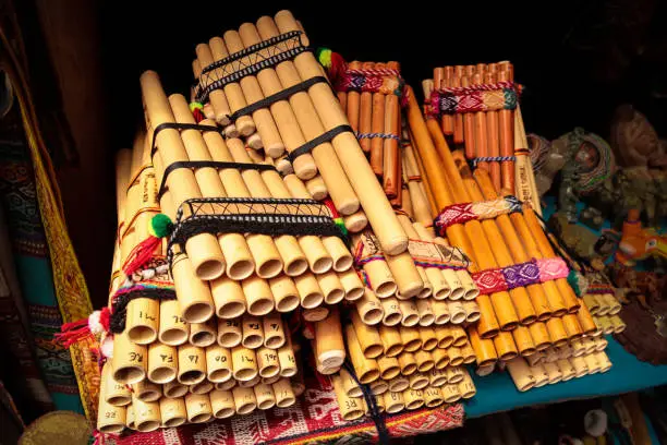 Set of pan flutes (siku) from South America on a stall in a local craft market in Peru, Cusco. Traditional Andean wind instruments.