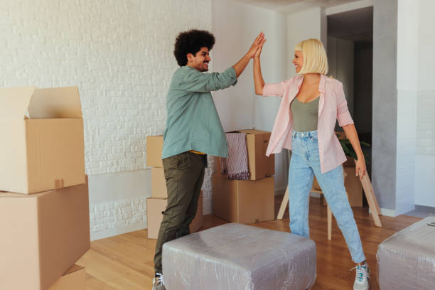 istock Joyful couple high five in apartment. 1445517193