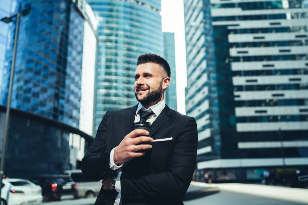 istock Smiling manager with coffee takeaway in city 1445519948