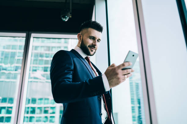 istock Happy adult office employee using smartphone 1445520047